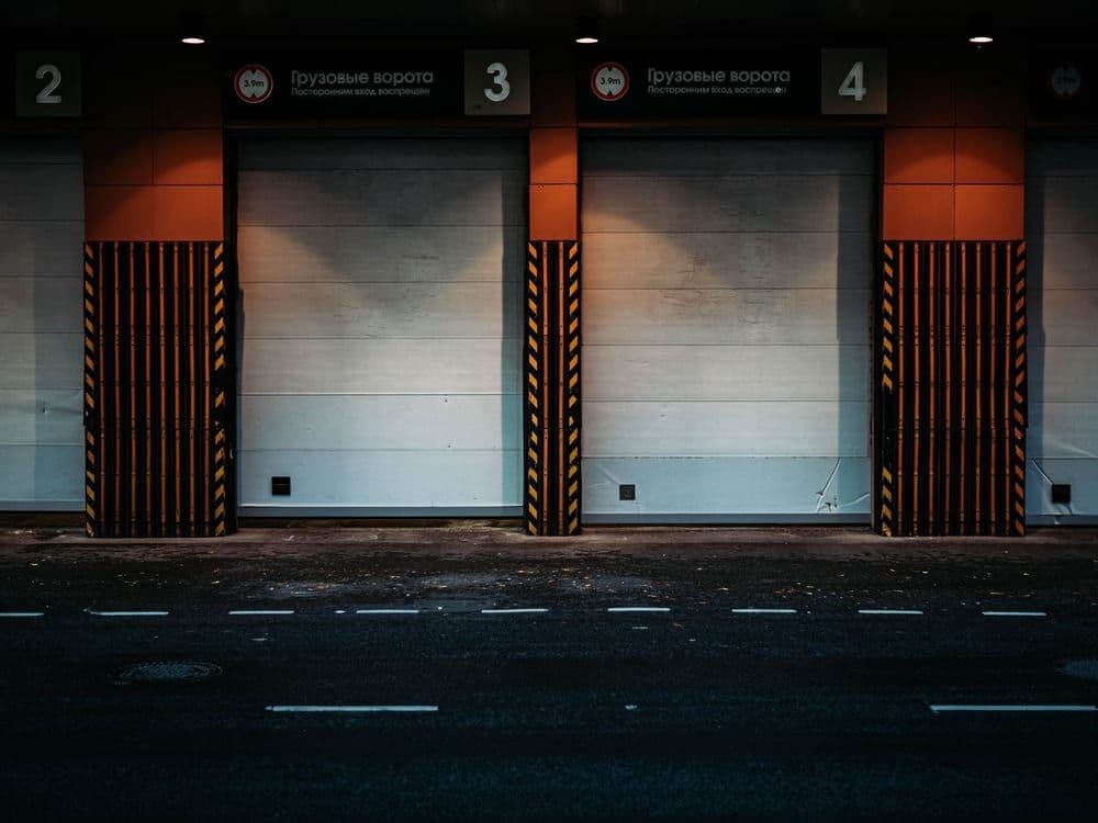 A row of industrial roller shutter doors on a commercial unit.